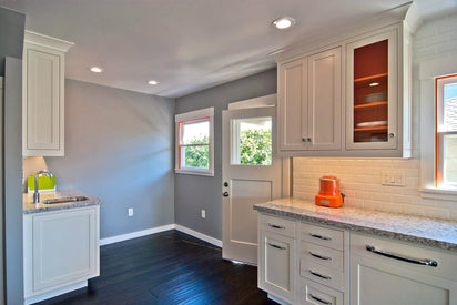 Interior painting project by MoonDance Painting — gray walls with white trim and dark hardwood floors